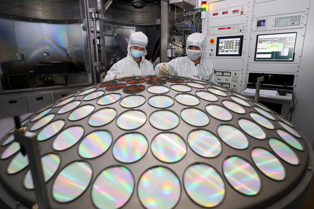 Employees work on the semiconductor chip production line in a factory in Huaian, Jiangsu province. Photo: China Daily