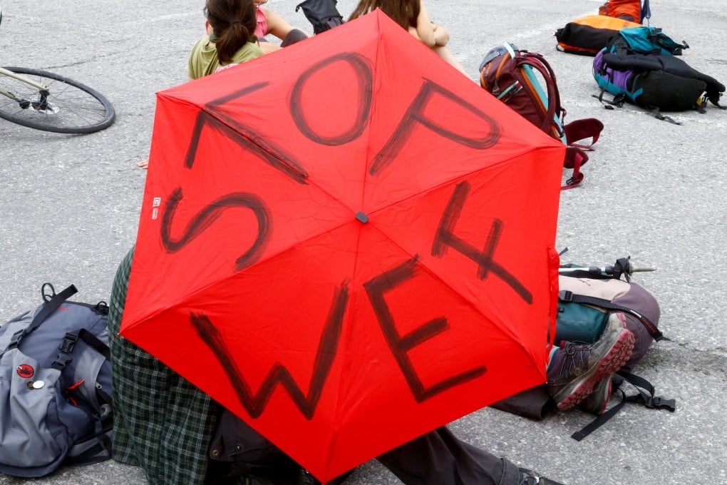 A protester holds up an umbrella during a protest against the World Economic Forum meeting, which has now ended. Reuters