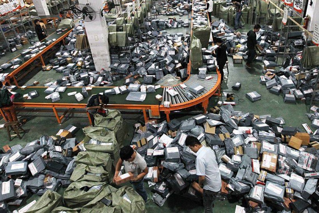 Express delivery staff deal with a mass of parcels in a warehouse in Wenzhou. The impossibility of making a decent living without an adequate education is a common theme in author Dan K. Woo’s short stories about life in modern China. Photo: Getty Images