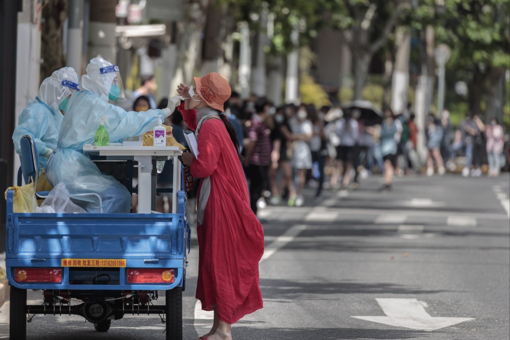 A woman takes a PCR test on an improvised mobile testing booth made from a cargo motorcycle in Shanghai. Photo: EPA-EFE