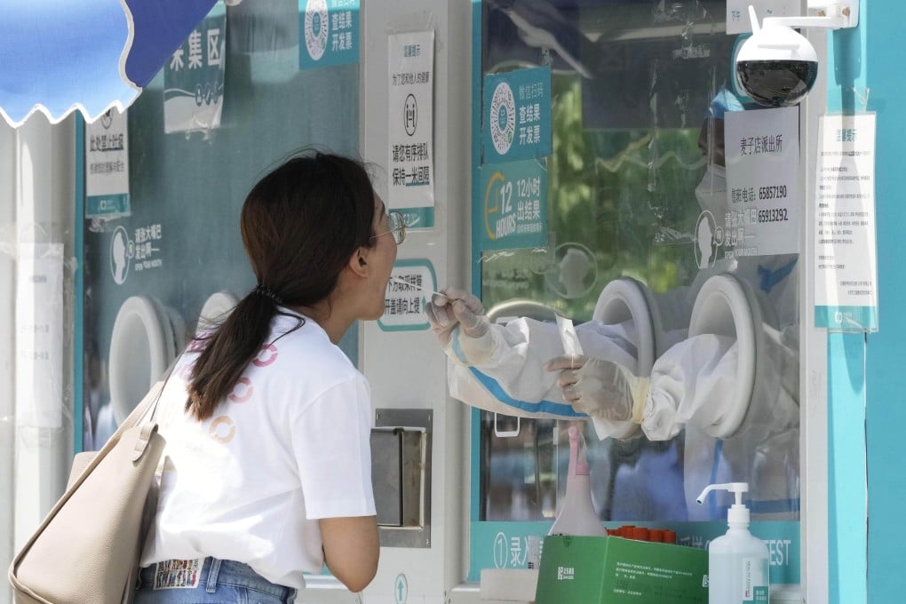 A woman takes a Covid-9 test in Beijing. Photo: Getty Images