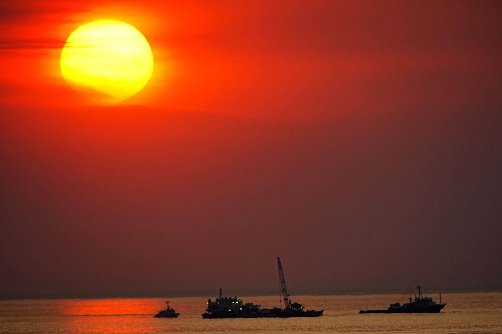 A barge tries to salvage a sunken tour boat from a depth of about 180 metres off the Japanese main island of Hokkaido. The tour boat, which sank in late April with 26 people aboard, dropped back to the seabed while being towed by the barge operated by a salvage company on May 24. Photo: Kyodo