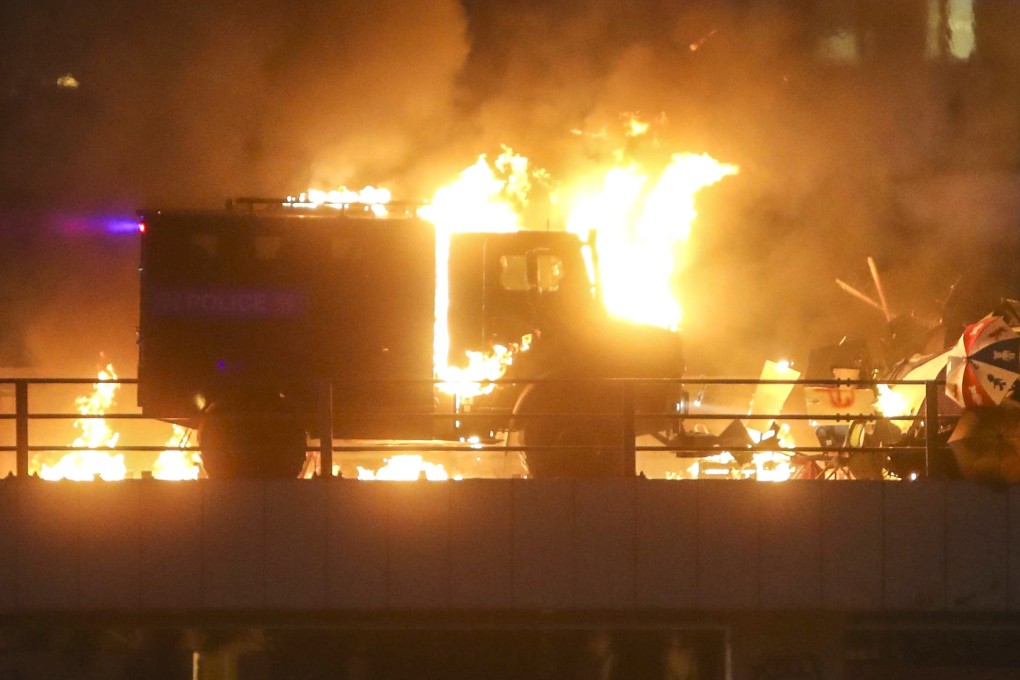 An armoured vehicle set on fire by petrol bombs during clashes between riot police and protesting students at Hong Kong Polytechnic University in November 2019. Photo: Winson Wong