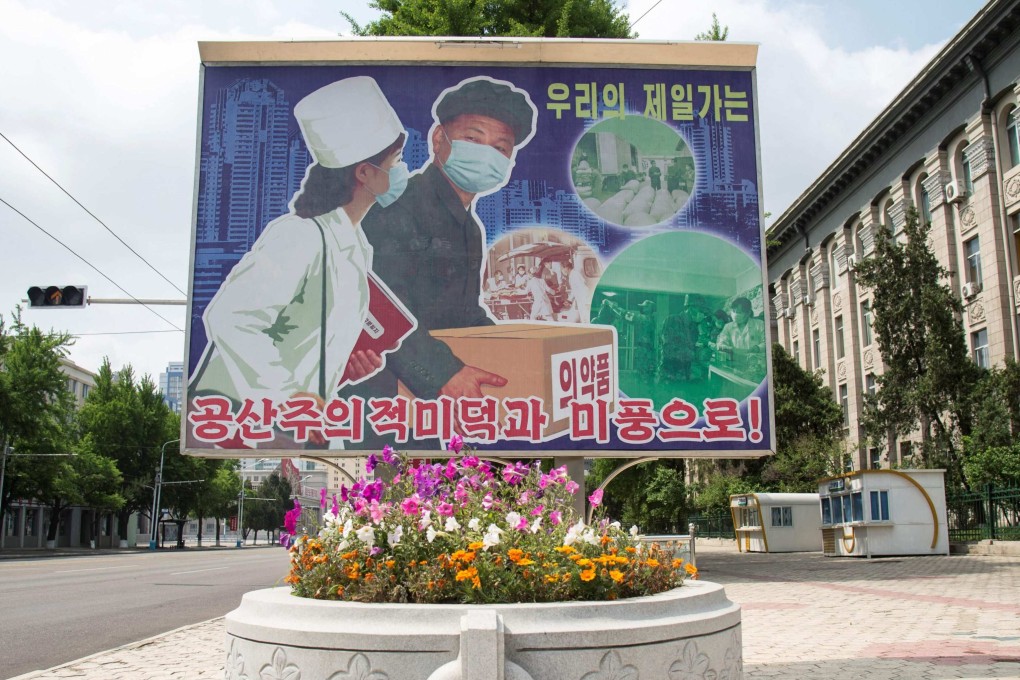 A poster displayed outside Pyongyang Department Store No.1 reads ‘Displaying beautiful communist virtues and traits’. Photo: AFP
