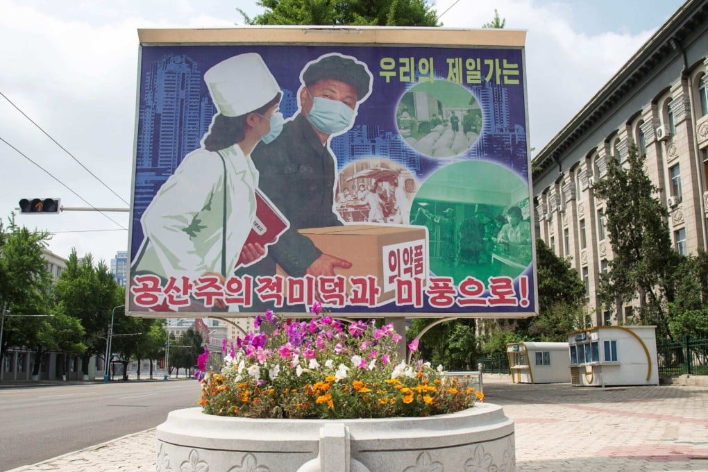 A poster displayed outside Pyongyang Department Store No.1 reads ‘Displaying beautiful communist virtues and traits’. Photo: AFP