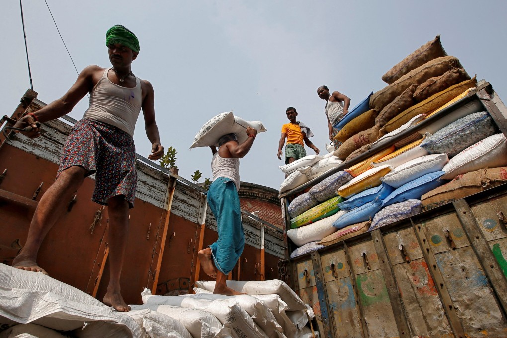 Sacks filled with sugar being loaded onto a supply truck at a wholesale market in Kolkata, India. Photo: Reuters
