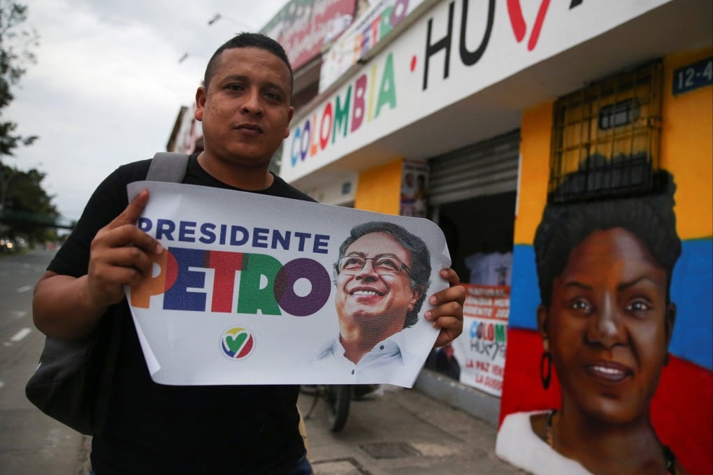 A supporter of Colombian left-wing presidential candidate Gustavo Petro poses with a sign showing his image shortly before the election. Photo: Reuters