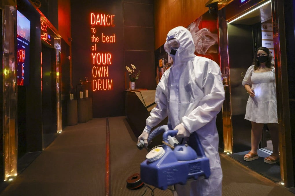 Cleaners disinfect Zentral club in the California Tower in Lan Kwai Fong, following an outbreak of Covid-19 cases at the club. Photo: Dickson Lee