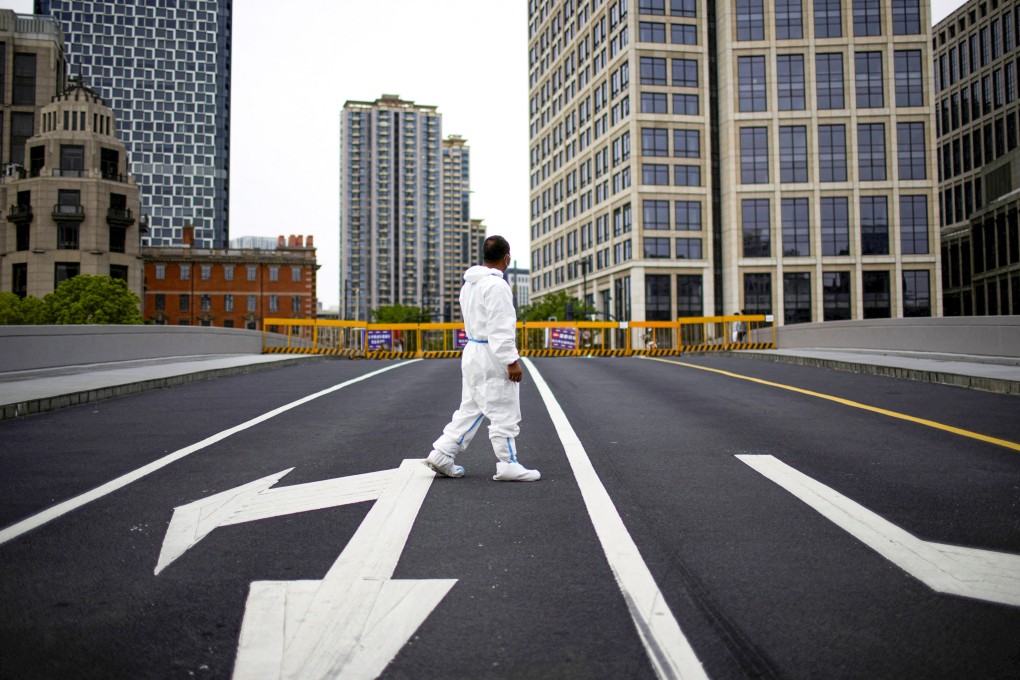 A worker in a protective suit on a closed bridge and empty roads during a citywide lockdown in Shanghai on May 18, 2022. Photo: Reuters.