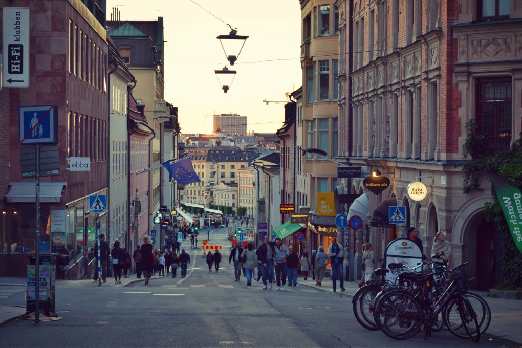 People walk down a street in Stockholm, Sweden, in 2017. Photo: Nick Walker