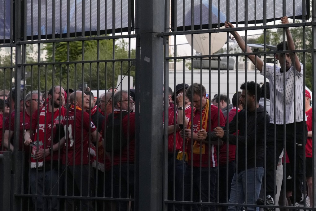 A fan climbs on the fence in front of the Stade de France in Saint Denis near Paris prior to the Champions League final between Liverpool and Real Madrid on Saturday. Photo: AP