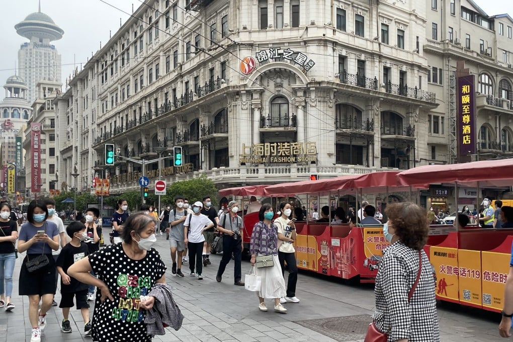 Shoppers and traffic returned to Nanjing Road East, one of Shanghai’s most famous shopping strips, after the city’s lockdown formally ended on June 1, 2022. Photo: Tracy Qu