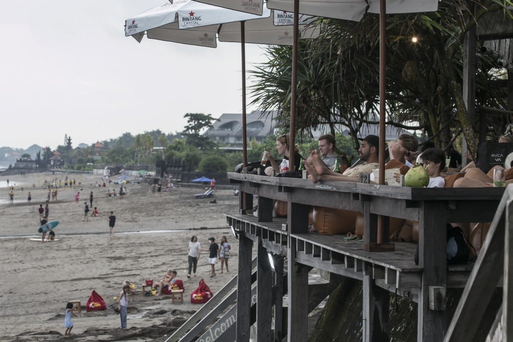 Tourists at a bar on Bali’s Batu Bolong Beach in Canggu, a once peaceful paradise known by few now overrun with hotels, resorts and restaurants. Photo: Getty Images