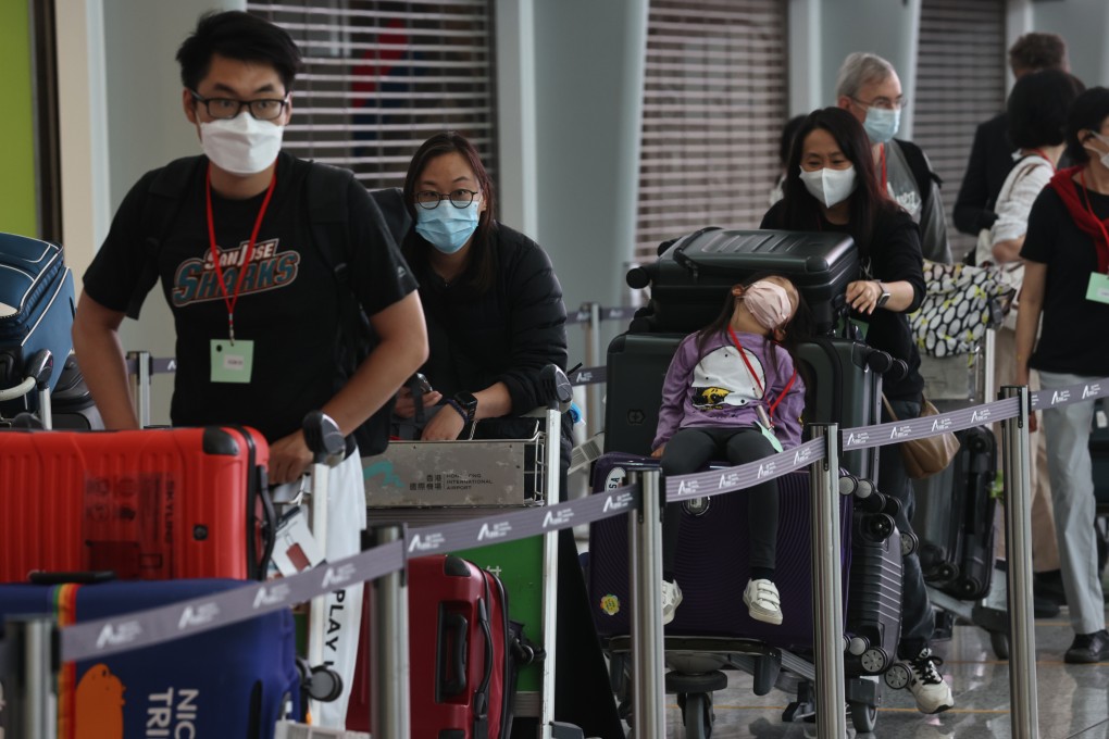 Passengers queue at Hong Kong International Airport for their quarantine hotel arrangement. Photo: K. Y. Cheng