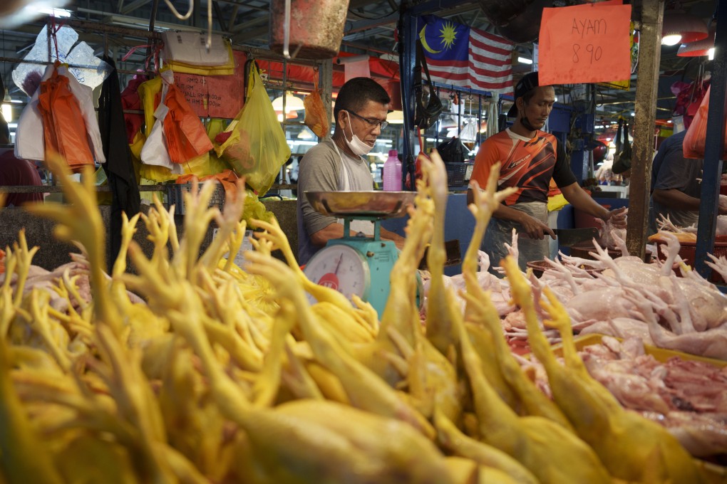 A seller prepares freshly butchered chickens at a wet market in Kuala Lumpur. Photo: AP