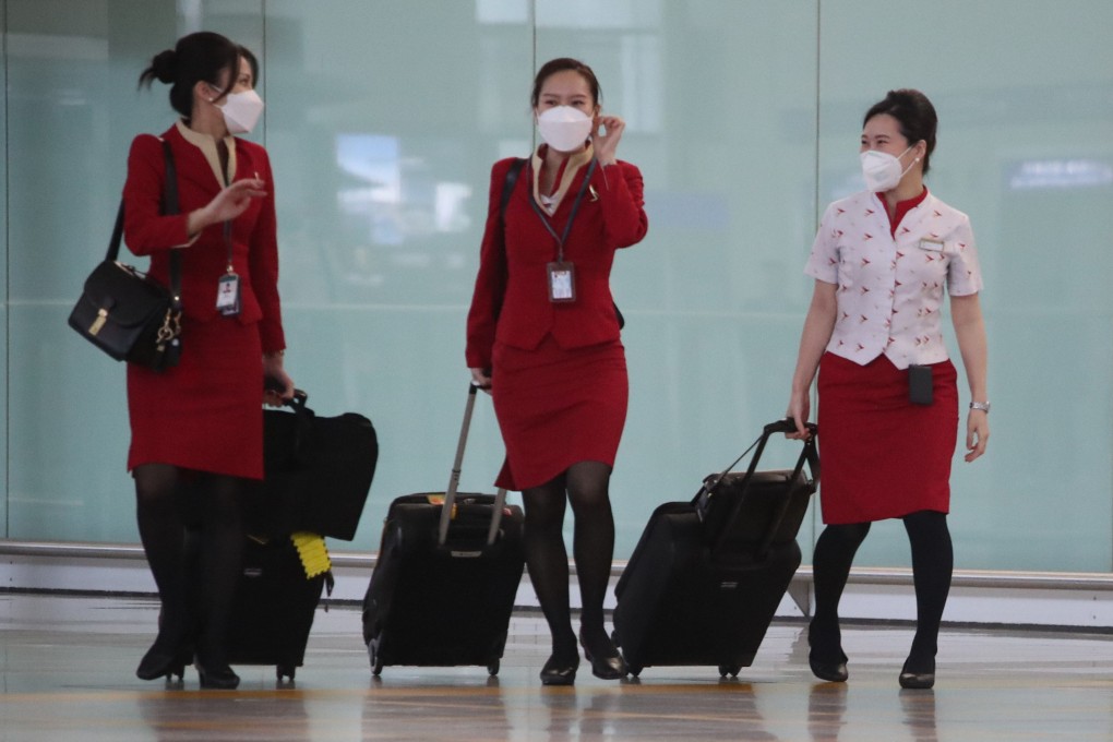 Cathay Pacific cabin crew members enter the arrival hall at Hong Kong International Airport on March 25. Aviation is beginning to see signs of recovery as travel resumes. Photo: Edmond So