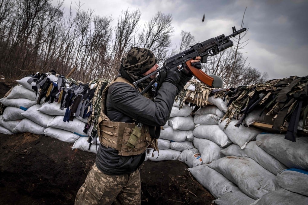 A Ukrainian serviceman shoots at a Russian drone with an assault rifle from a trench at the front line east of Kharkiv on March 31, 2022. Chinese military researchers predict drones armed with facial recognition and AI will be used in future conflicts. Photo: AFP