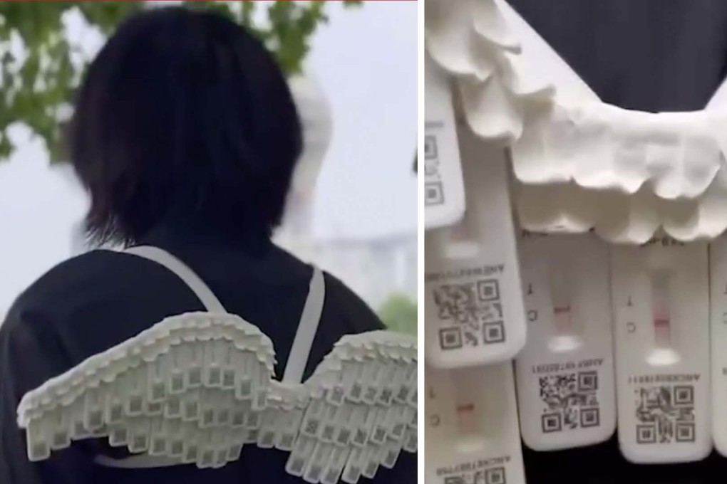 A man visits Shanghai landmarks wearing a pair of angel wings made with rapid antigen test cassettes to celebrate end of the city’s lockdown. Photo: SCMP