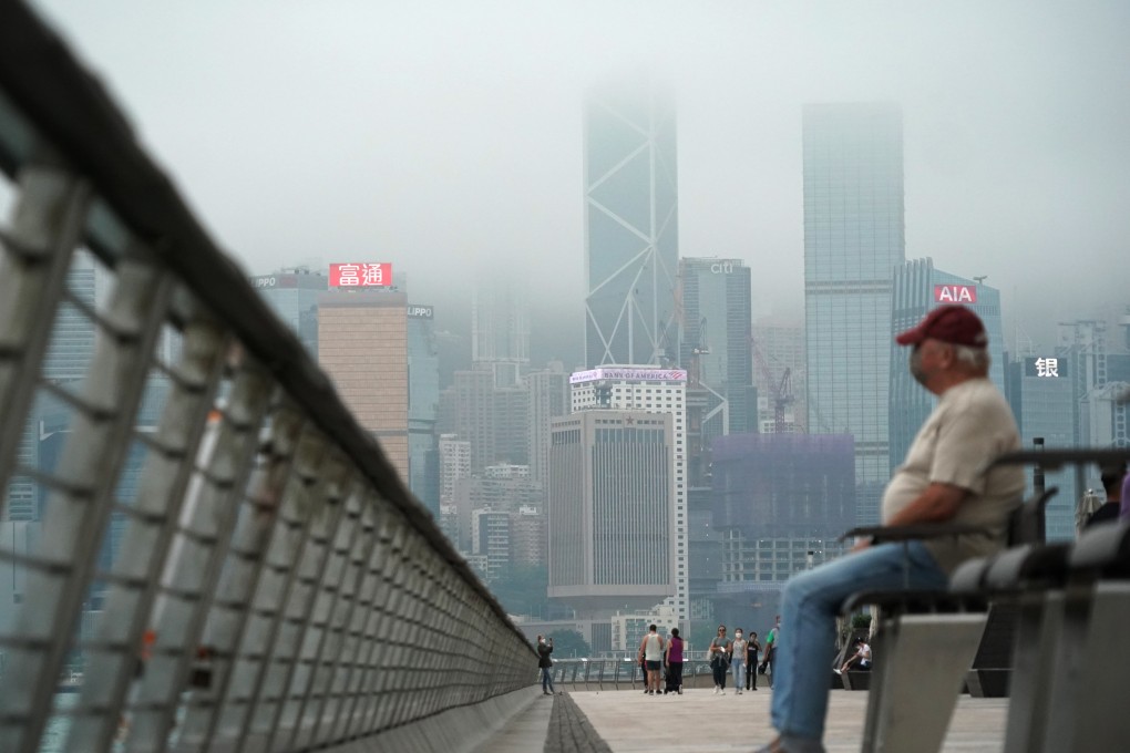 Fog hangs over the Hong Kong skyline as people gather on the Tsim Sha Tsui promenade on May 23. Photo: Felix Wong