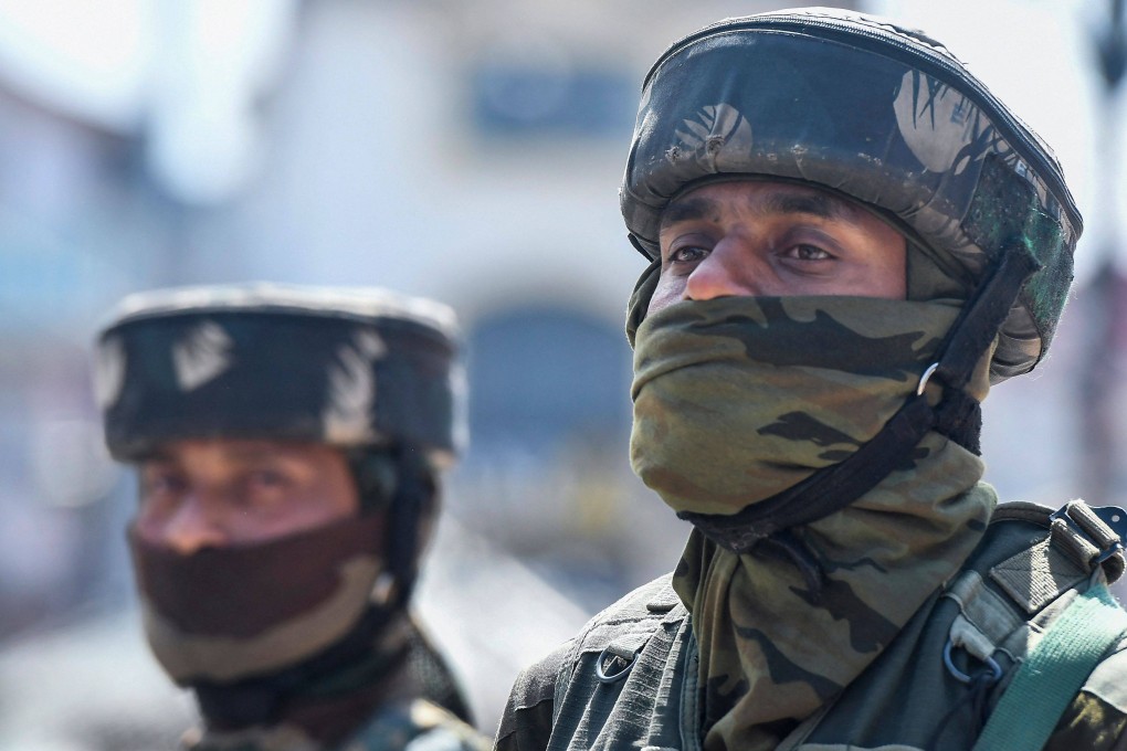 Indian paramilitary troopers stand guard along a street during a random search in Srinagar on Thursday. Suspected rebels shot dead a Hindu bank manager in Indian-administered Kashmir, police said -- the latest in a spate of targeted killings in the disputed territory. Photo: AFP
