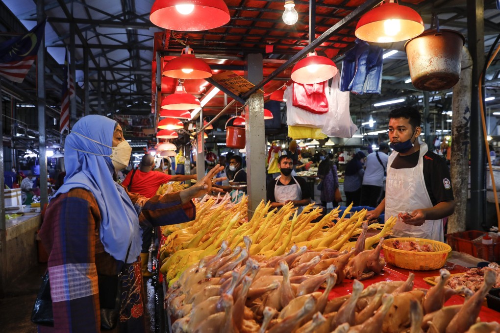 A woman shops at at wet market in Kuala Lumpur. Photo: EPA-EFE