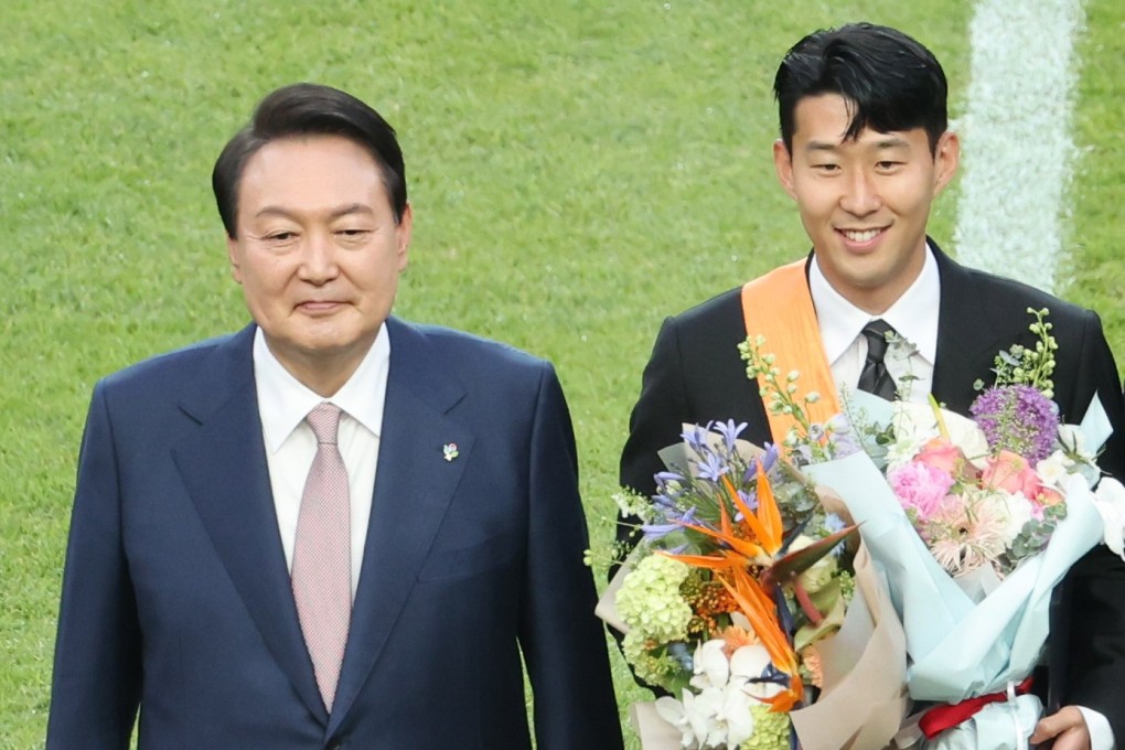 South Korean President Yoon Suk-yeol (left) and Tottenham Hotspur’s South Korean forward Son Heung-min pose for the camera after Yoon awarded the player an order of merit in recognition of his achievement in sports. Photo: EPA-EFE