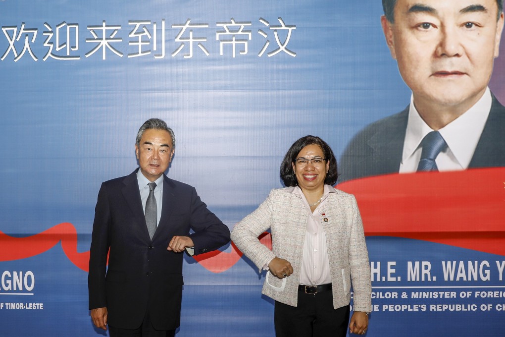 Chinese Foreign Minister Wang Yi (left) greets East Timorese Foreign Minister Adaljiza Magno during a stop in Dili, East Timor, on Friday. Photo: EPA-EFE