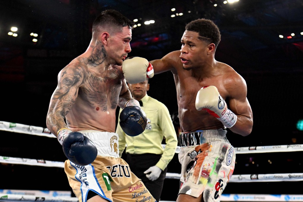 Devin Haney (right) connects with a right against George Kambosos during their lightweight title fight in Melbourne. Photo: AFP