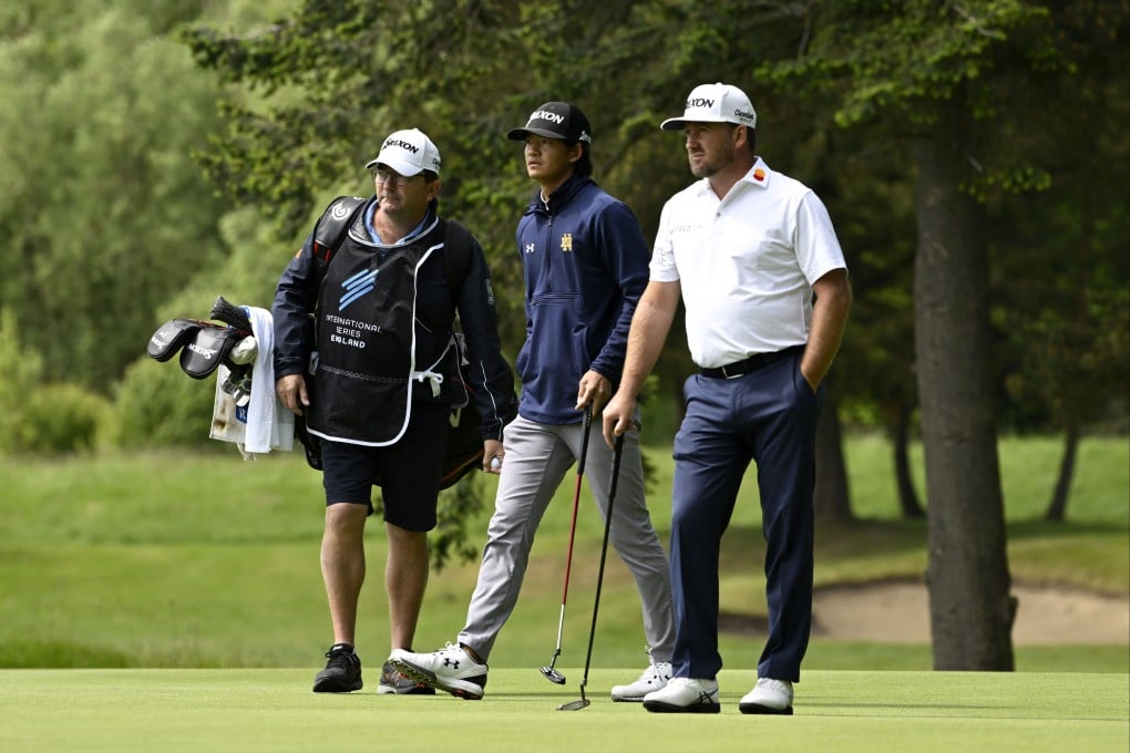Hong Kong’s Taichi Kho (left) and Graeme McDowell wait to putt during the third round of the International Series England tournament. Photo: Asian Tour.