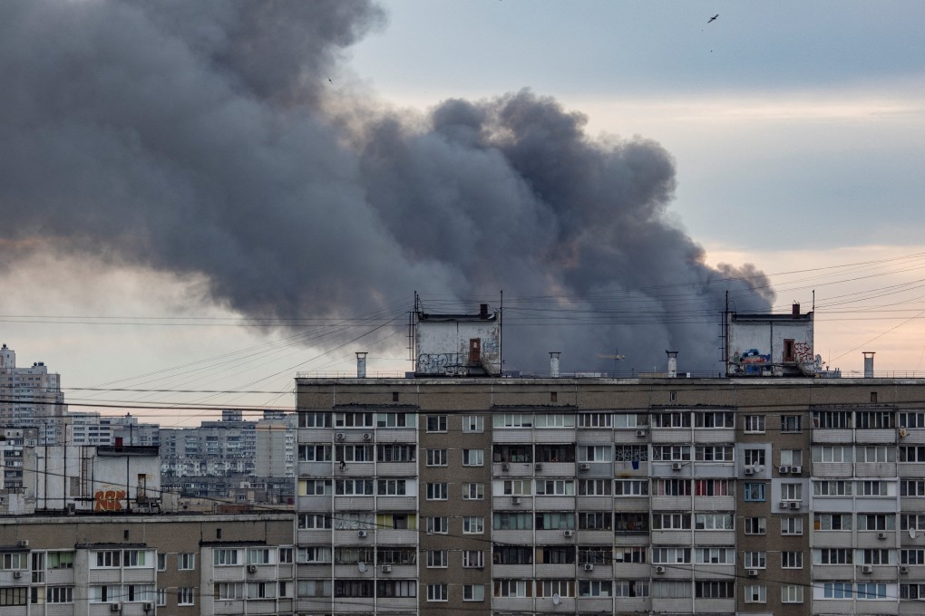Smoke rises from a building in Kyiv on Sunday after the Russian missile strikes. Photo: Reuters