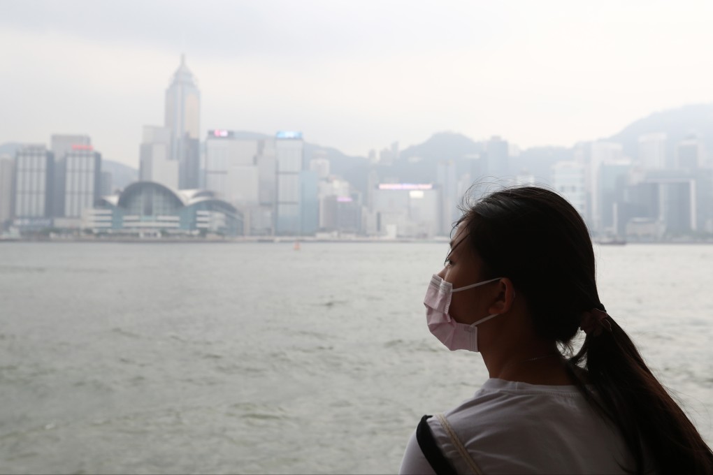 A woman wears a mask along the Tsim Sha Tsui promenade on a polluted day in 2018. Photo: Nora Tam