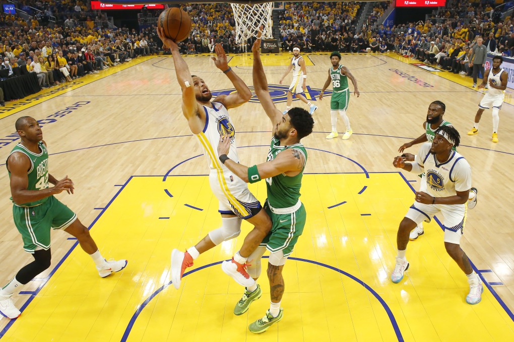 Golden State Warriors guard Stephen Curry, middle left, shoots against Boston Celtics forward Jayson Tatum. Photo: AP