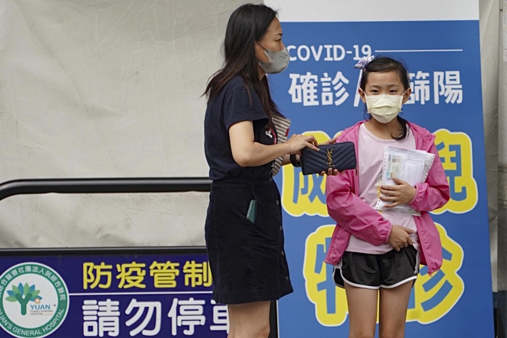 A mother takes her daughter to a special paediatric clinic in Kaohsiung, Taiwan on Wednesday. Photo: CNA