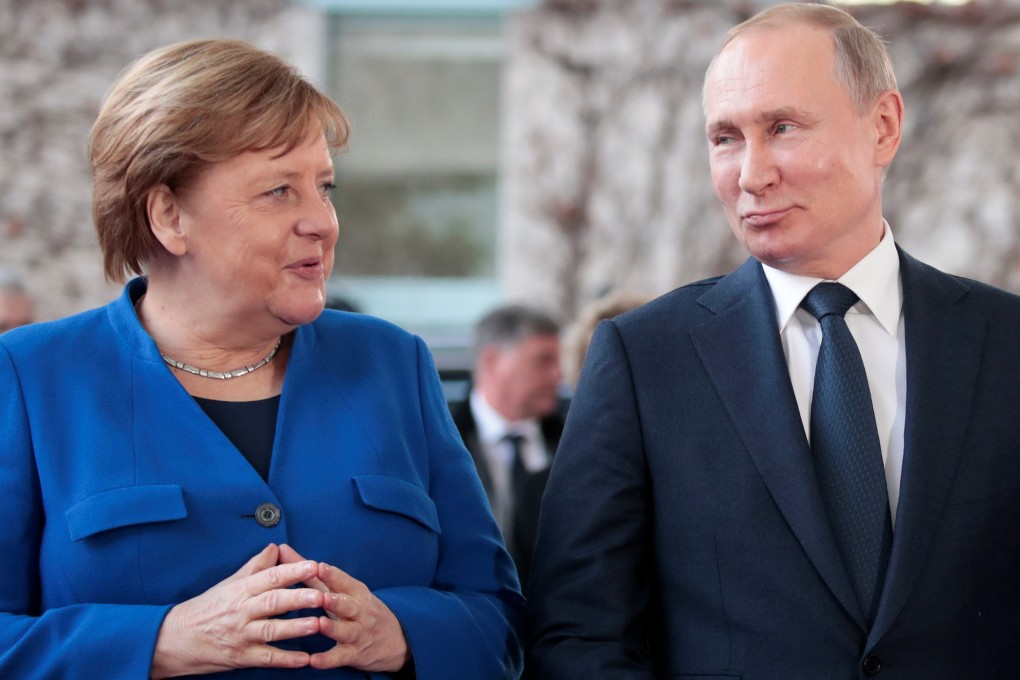 German Chancellor Angela Merkel and Russian President Vladimir Putin pose for a picture as he arrives to attend the Libya summit in Berlin in January 2020. Photo: Reuters