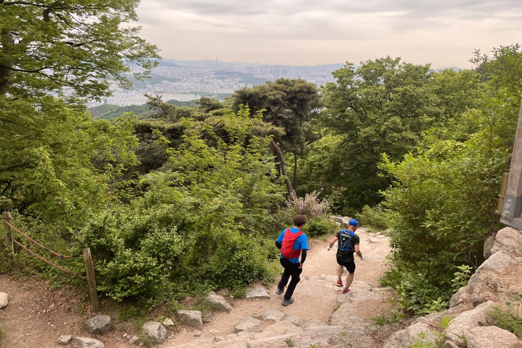 Two runners bound down a trail in Bukhansan National Park, Seoul, South Korea, part of the 40km Five Peaks trail running race that’s one of the hardest in the country. Photo: Matthew Crawford.