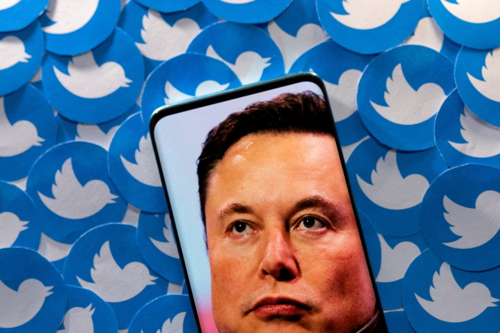 An image of Elon Musk seen on smartphone placed on printed Twitter logos in this picture illustration taken on April 28, 2022. Photo: Reuters