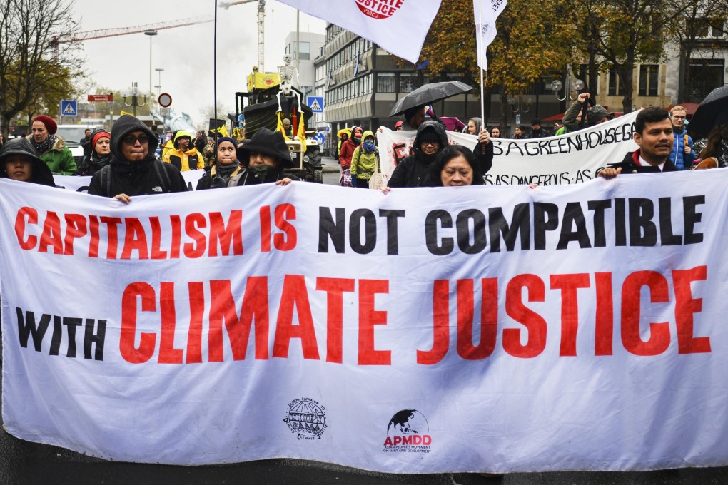Protesters carry banners as they take part in a demonstration during the UN Climate Change Conference in Bonn, Germany, on November 11, 2017. Photo: EPA-EFE