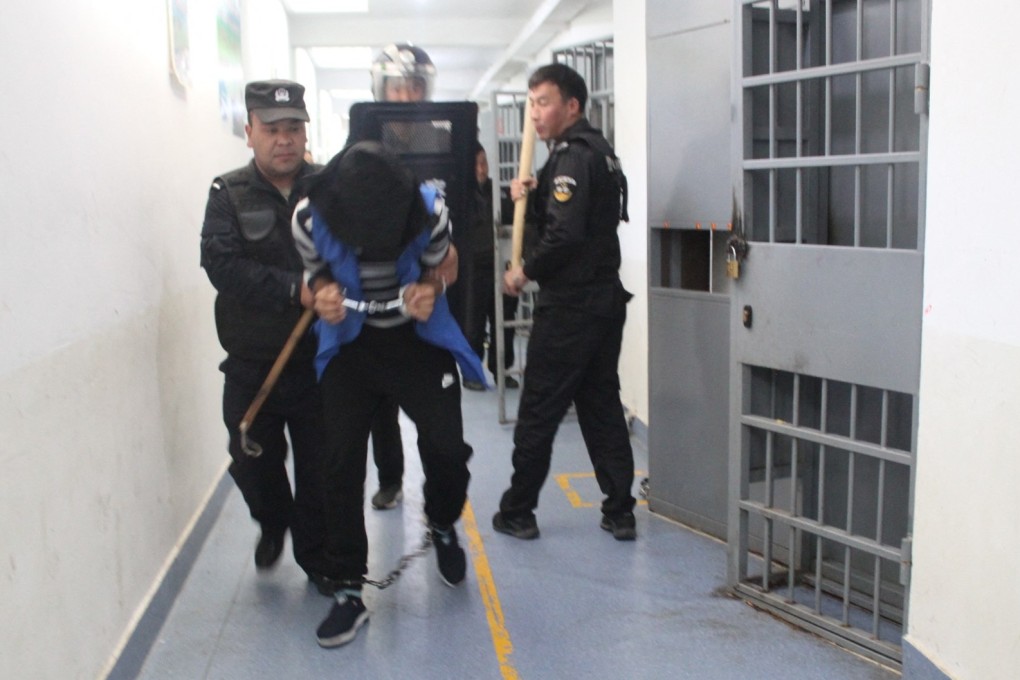 Security personnel engaged in an apparent anti-escape or anti-riot drill at the Tekes County Detention Centre in Xinjiang in February, 2018. Photo: AFP