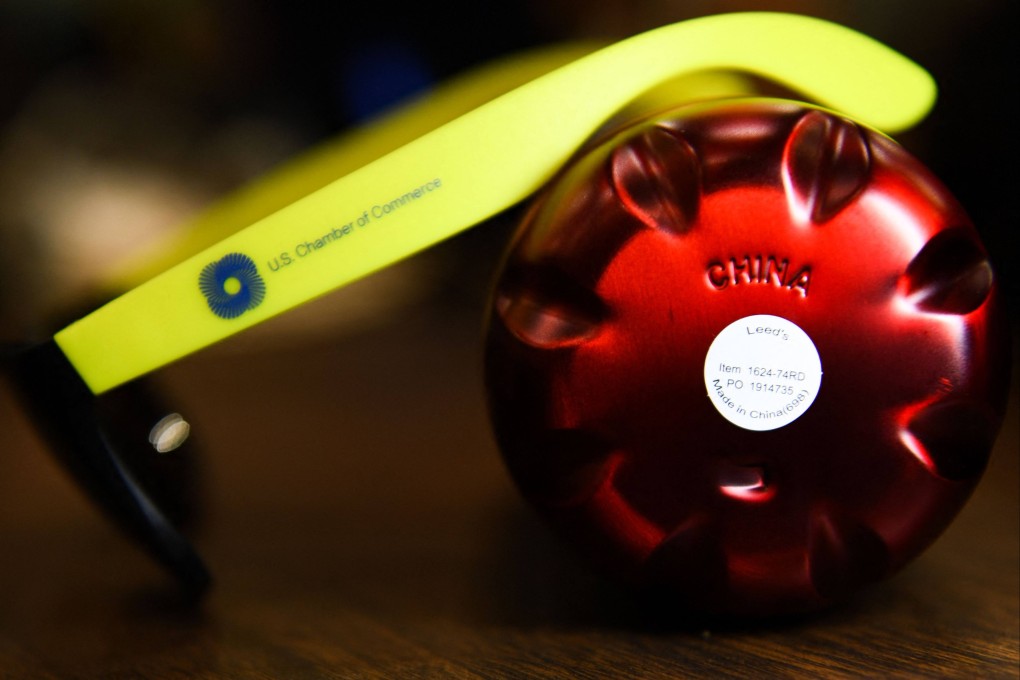 A water bottle and pair of plastic sunglasses with the logo of the US Chamber of Commerce, both with markings reading ‘Made In China’. Photo: AFP
