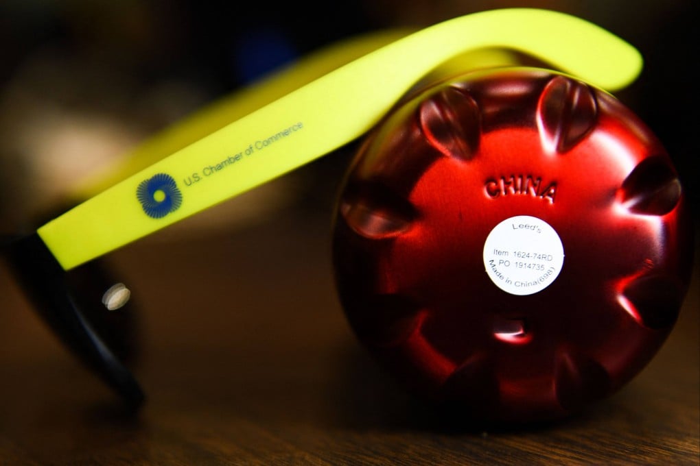 A water bottle and pair of plastic sunglasses with the logo of the US Chamber of Commerce, both with markings reading ‘Made In China’. Photo: AFP