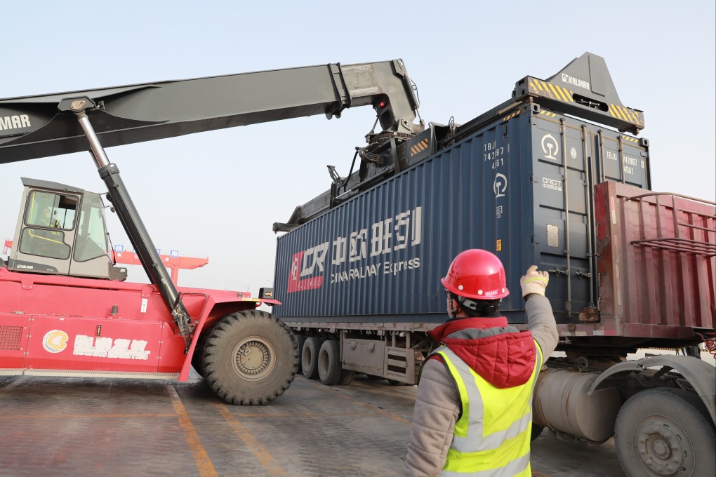 Workers unload imported goods from one of the China-Europe freight trains at a railway station in Lanzhou, northwest China. Photo: Xinhua