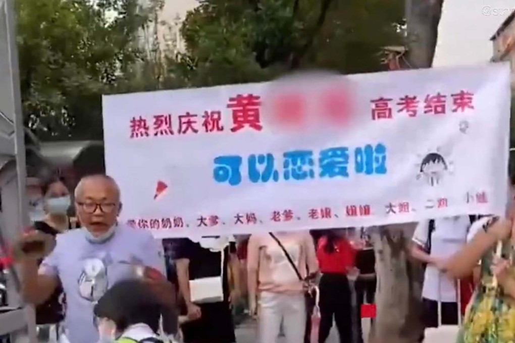 Cheerful family members wave a banner outside an exam venue celebrating that their daughter now has time to ‘fall in love after completing the gaokao. Photo: Toutiao