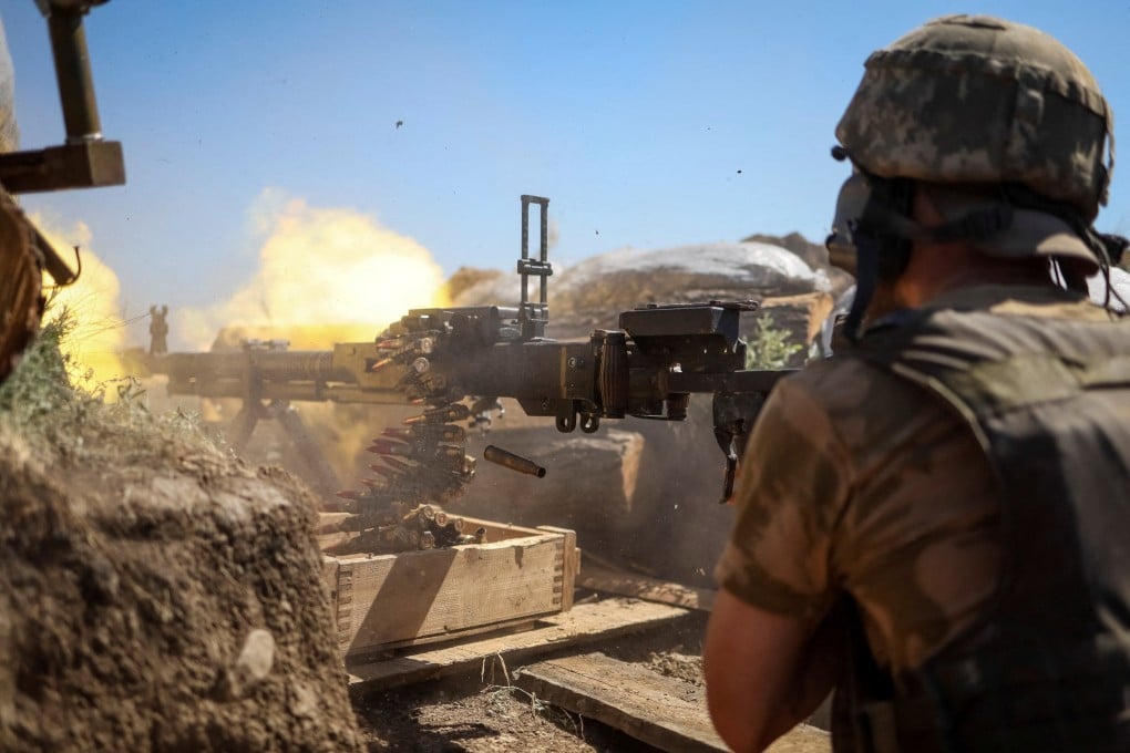 A Ukrainian service member fires a machine gun from a position on the front line in the Donetsk region on Thursday. Photo: Reuters