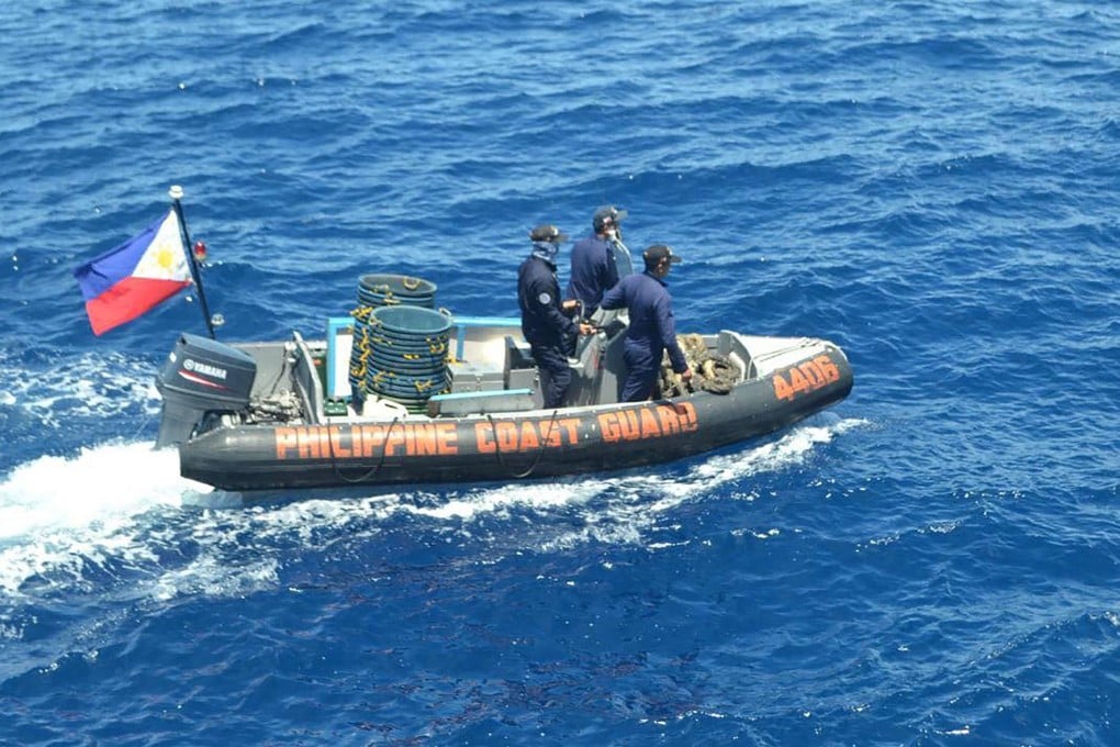 Philippine coast guard personnel patrol the sea off Maracanao Island in Palawan province. Photo: Philippine Coast Guard / AFP