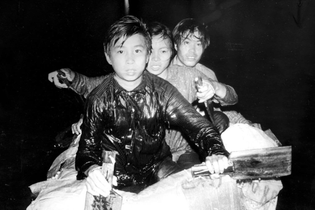 Three “freedom swimmers” from mainland China stare at their captors moments after a marine police patrol spots them in Deep Bay, Hong Kong, on November 11, 1979. Their raft is made of inflatable plastic cushions sewn together and covered with plastic bags.  Photo: C. Y. Yu