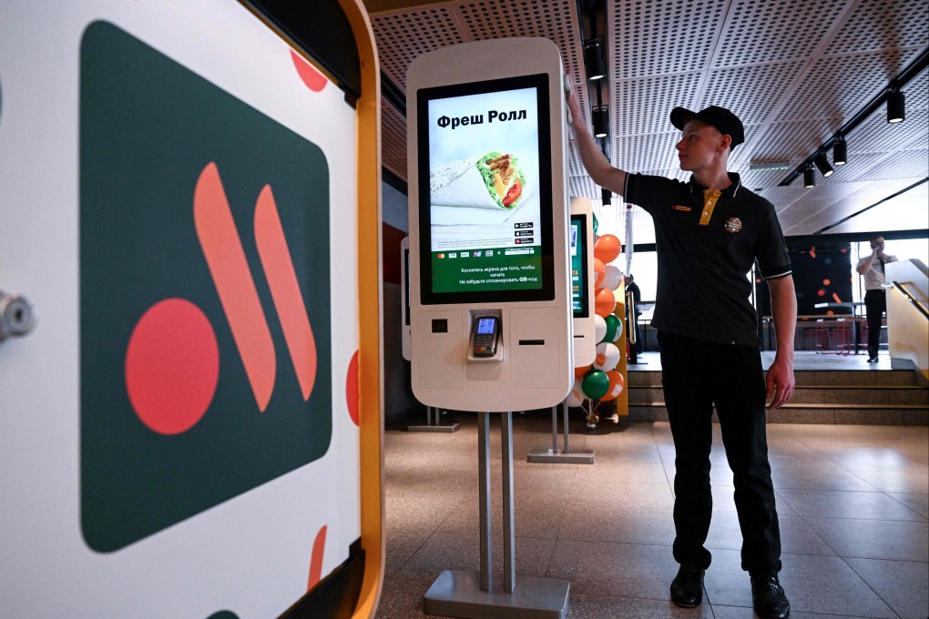 An employee cleans a self-ordering machine at the Russian version of a former McDonald’s restaurant in Moscow on June 12, 2022. Photo: AFP