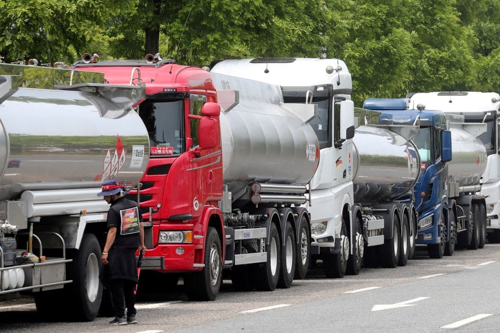A member of the Cargo Truckers Solidarity union stands next to a truck during a strike in South Korea. Photo: Yonhap via Reuters
