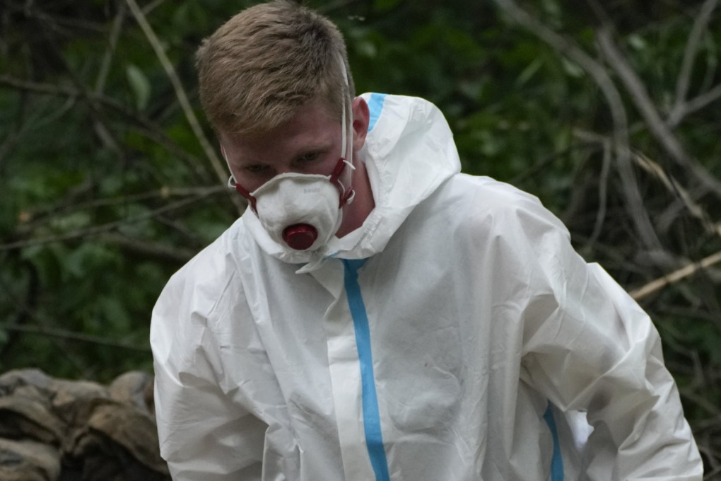 A member of an extraction crew at a mass grave near Bucha, on the outskirts of Kyiv, Ukraine. Photo: AP