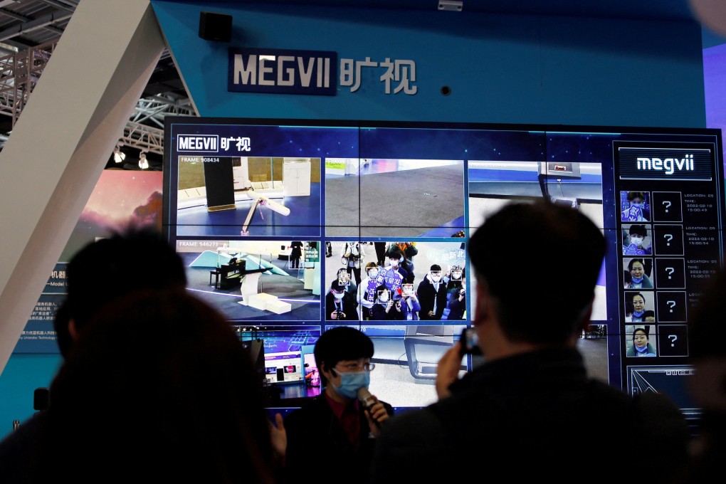 A staff member speaks in front of a display demonstrating the facial recognition system of Chinese artificial intelligence firm Megvii during an organised media tour at the Zhongguancun National Innovation Demonstration Zone Exhibition Center in Beijing on February 10, 2022. Photo: Reuters