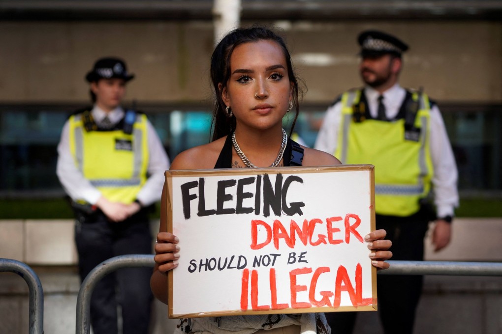 A protester outside the Home Office in central London. The British government was to send a first plane carrying failed asylum seekers to Rwanda on Tuesday. Photo: AFP